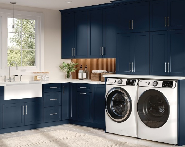 Blue cabinets in a laundry room with a sink